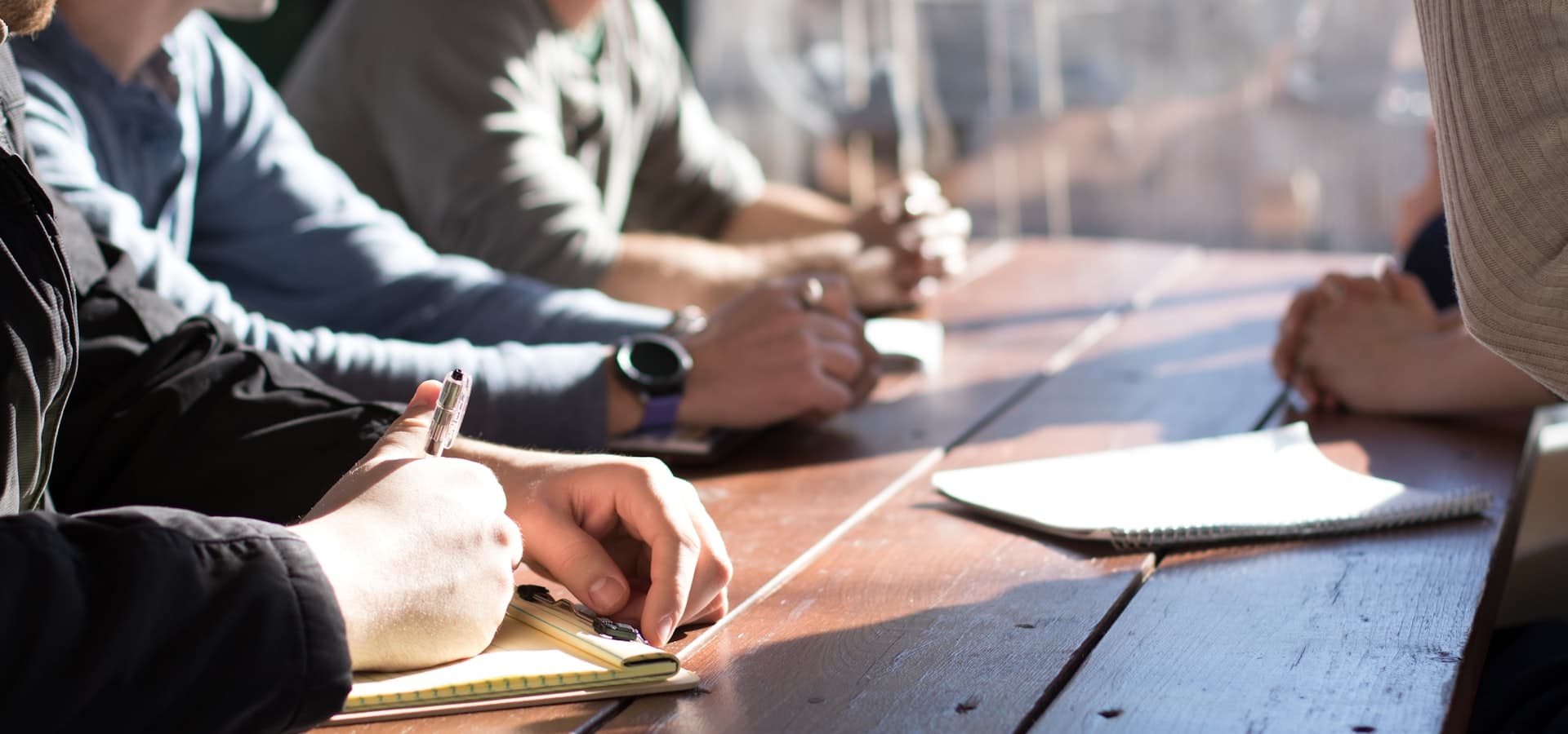 A team meeting around a table — connecting talent with opportunity